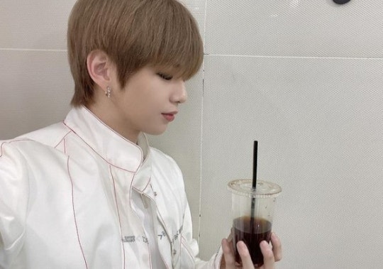 Daniel Kang wearing a white costume